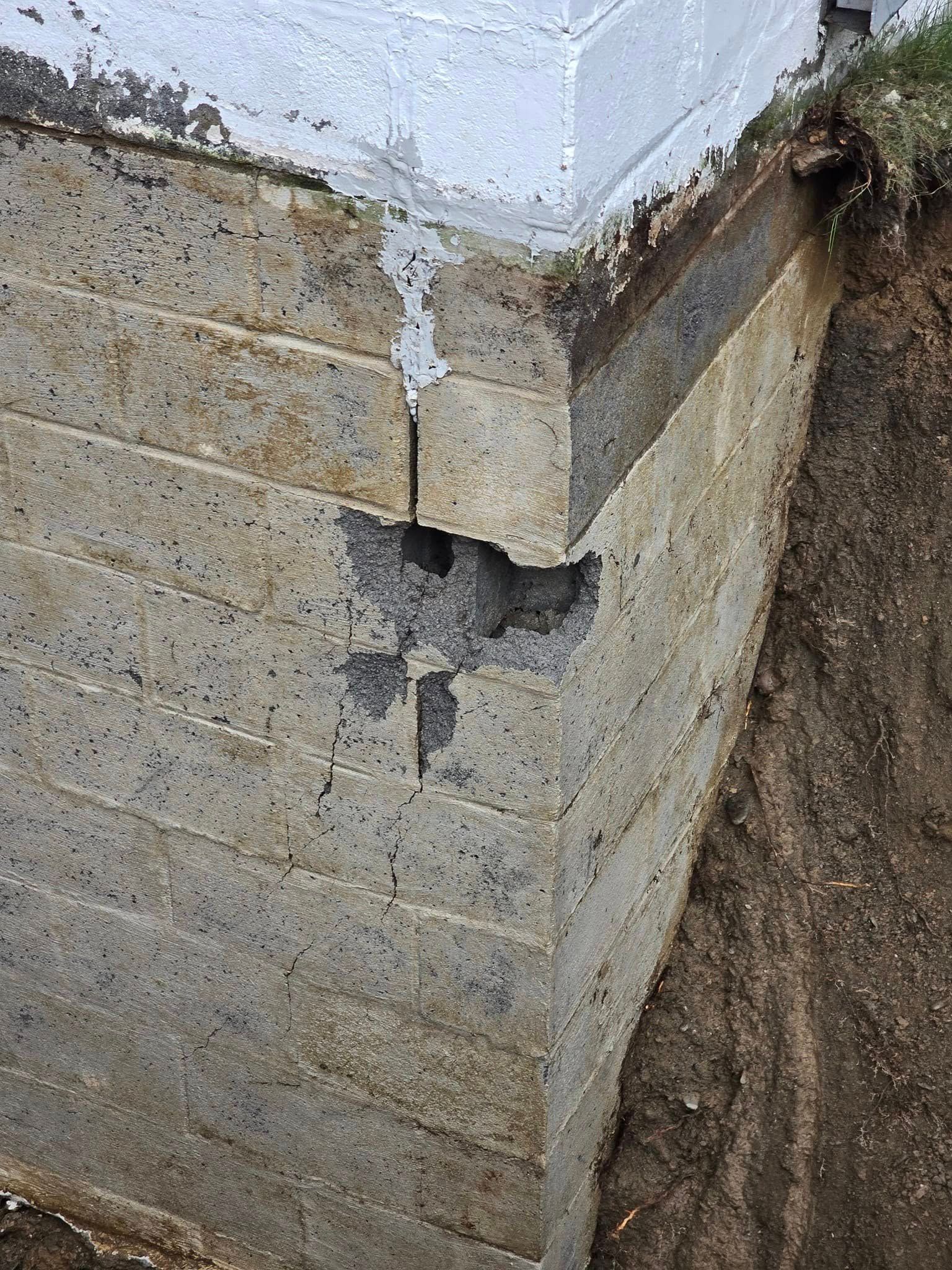 A close up of a concrete wall with a hole in it.