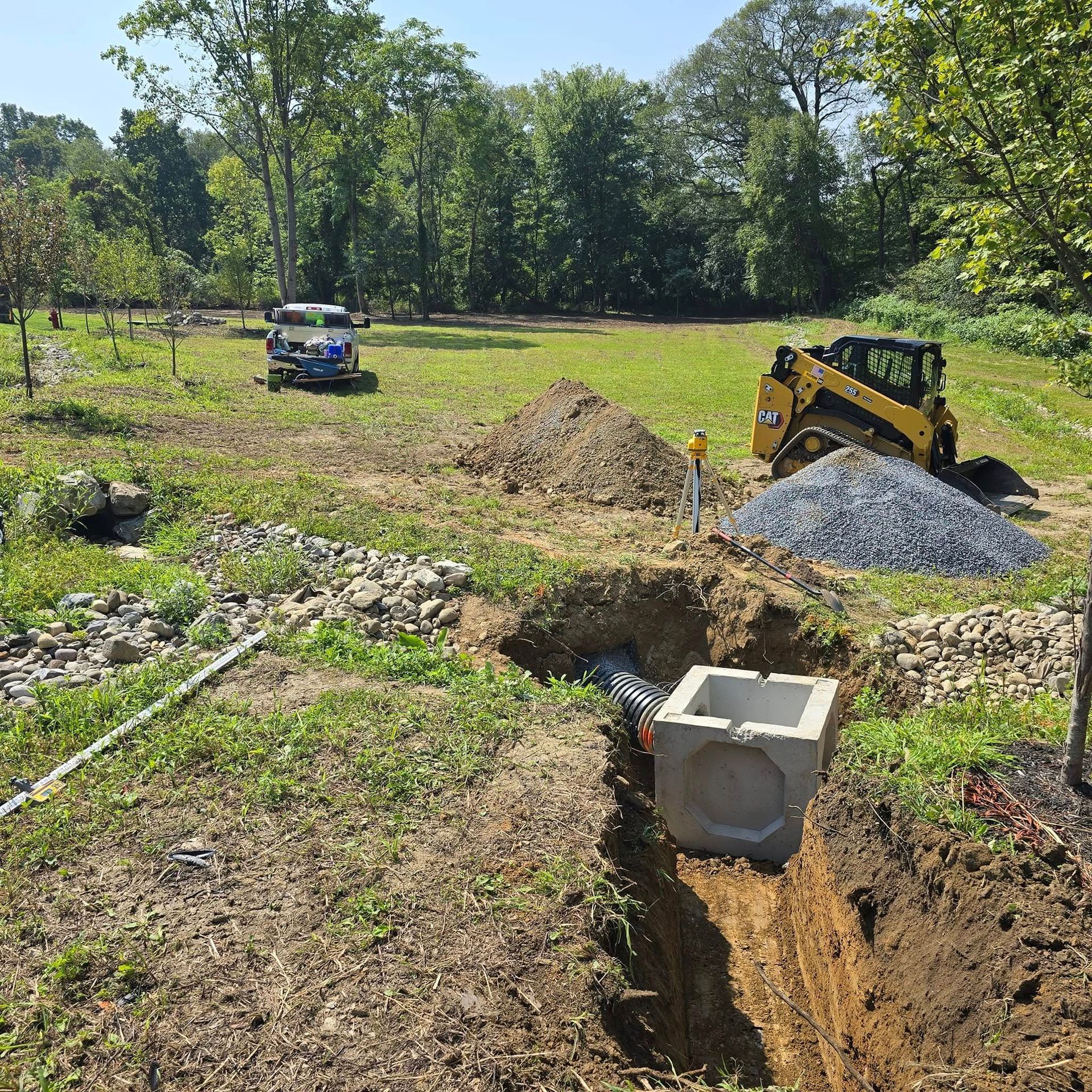 A bulldozer is digging a hole in the dirt in a field.