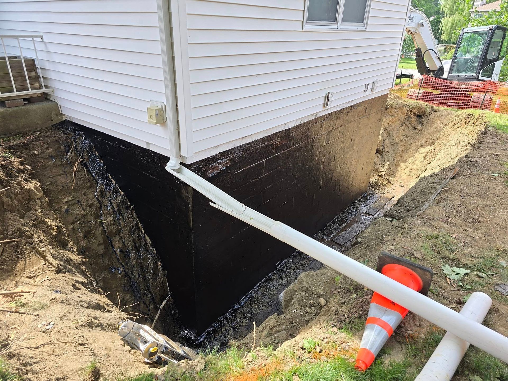 A house is being remodeled and a drainage system is being installed.
