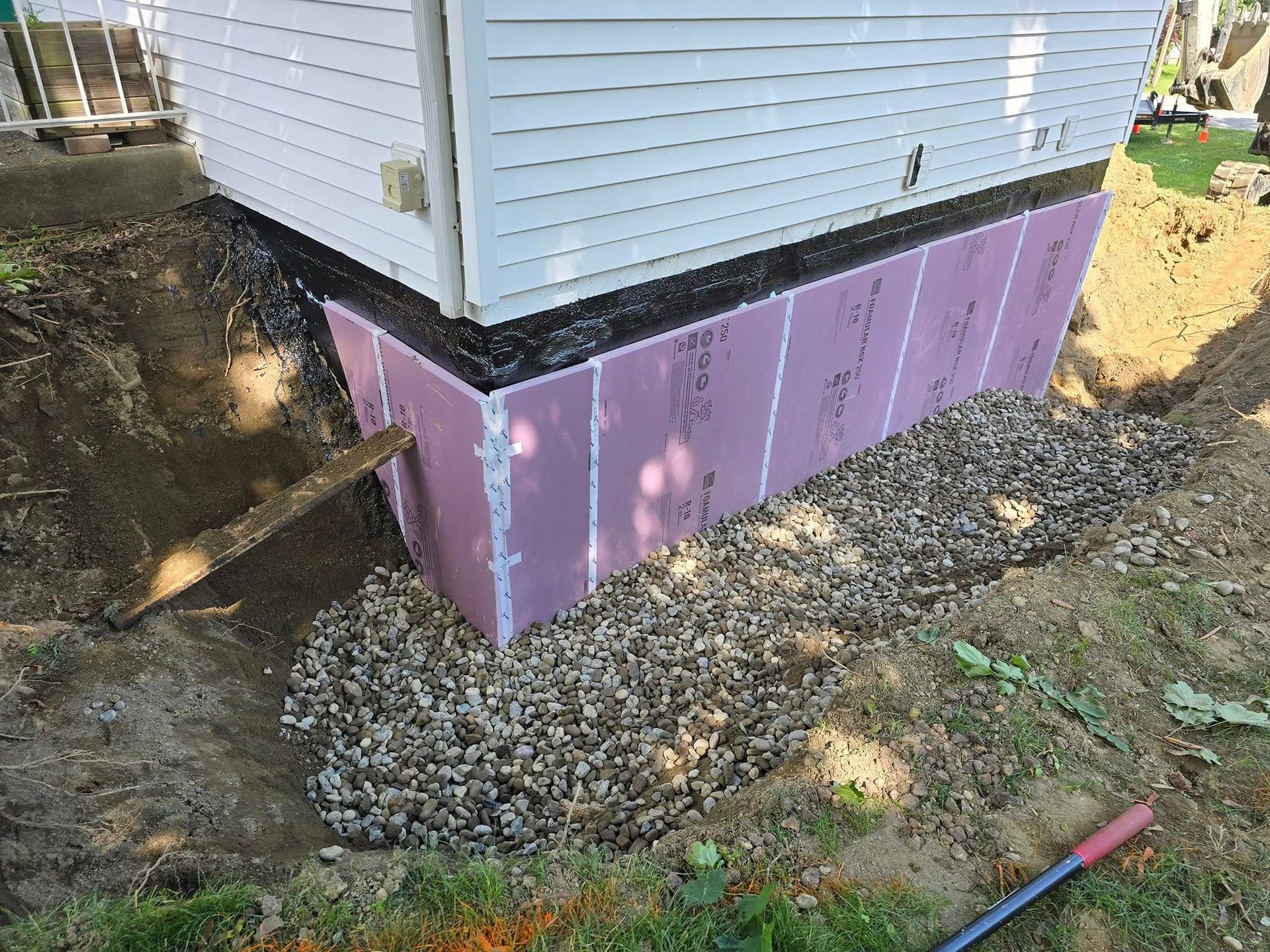 A white house with a pink foundation is being built.