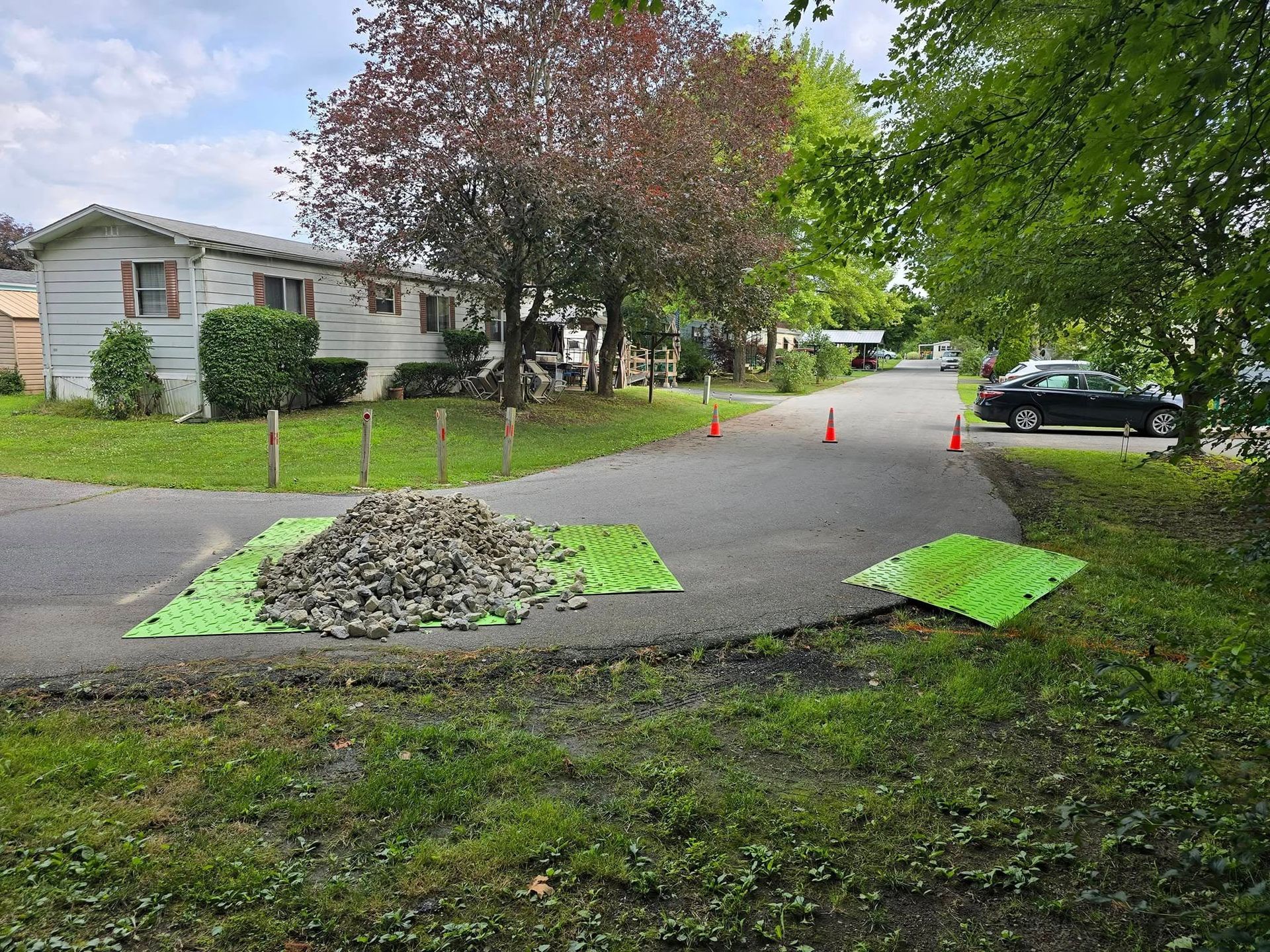 There is a pile of rocks on the side of the road.