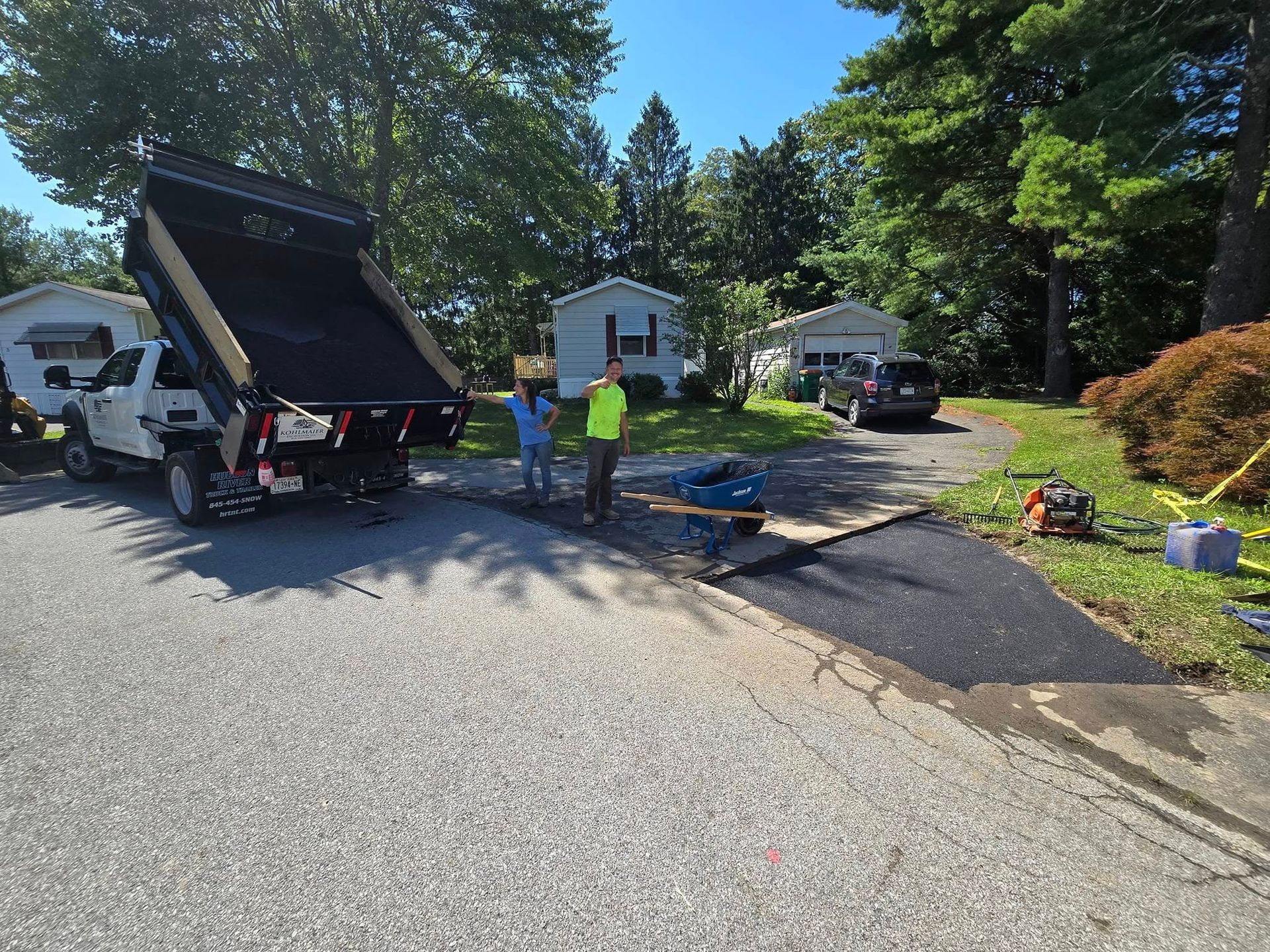 A dump truck is parked on the side of the road.