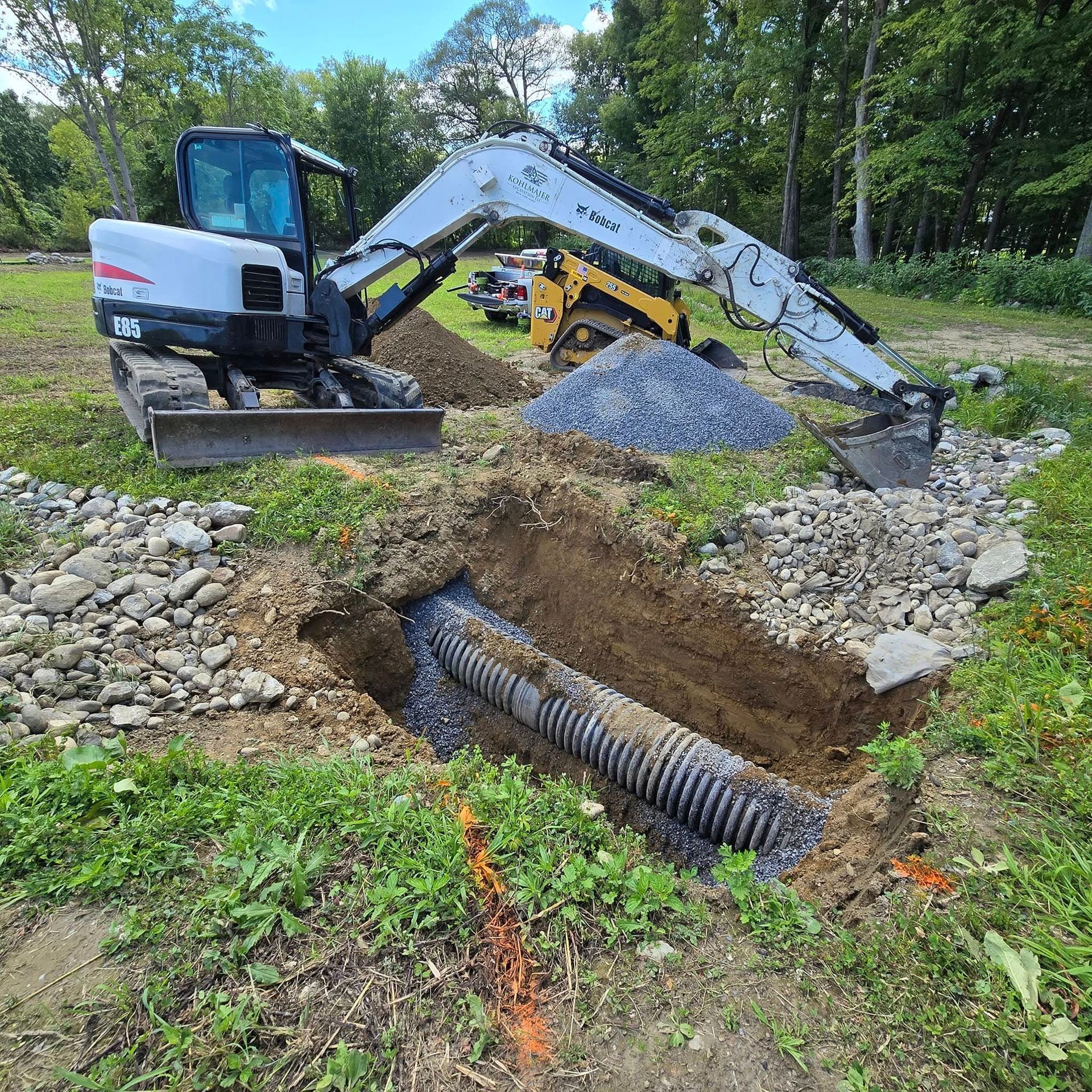 A bulldozer is digging a hole in the ground in a field.