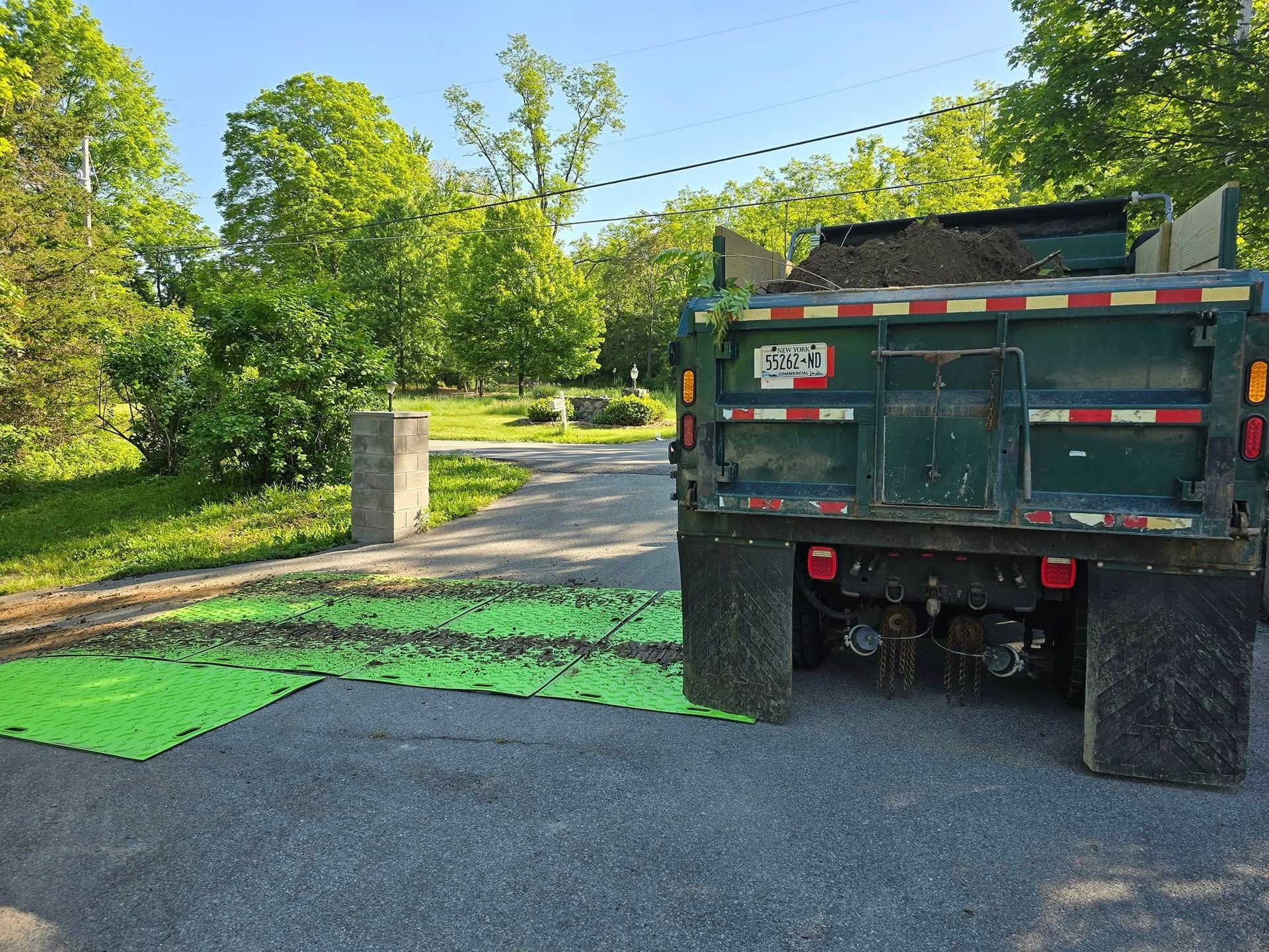 A dump truck is parked on the side of a road.