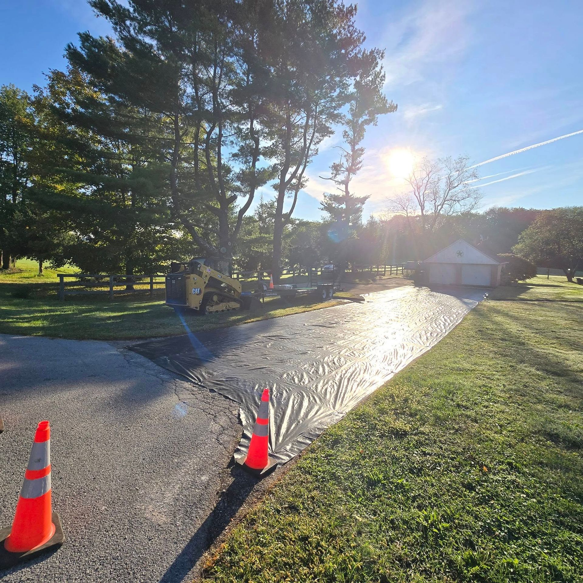 A sprinkler is spraying water on the side of a road