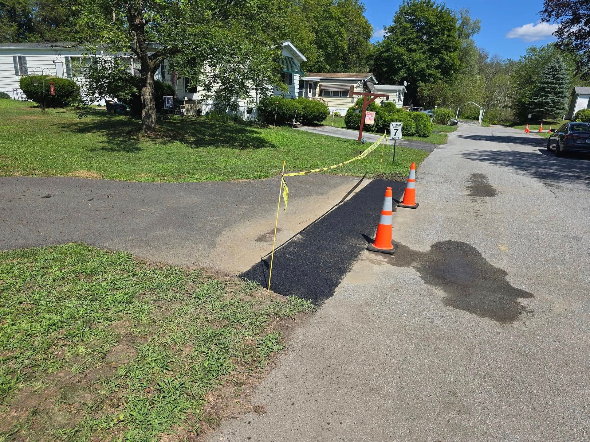 A couple of orange traffic cones on the side of a road