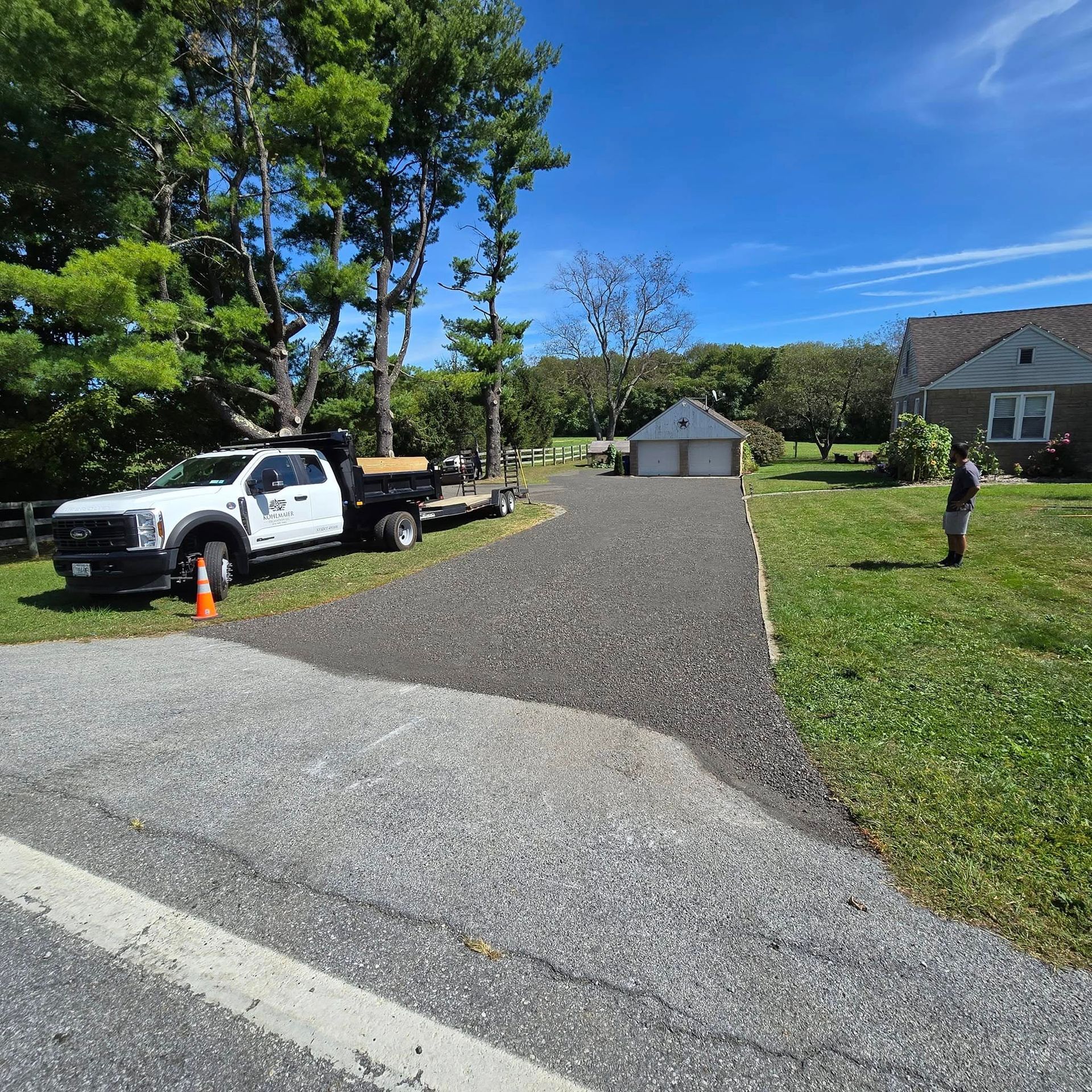 A white truck is parked in a driveway next to a house