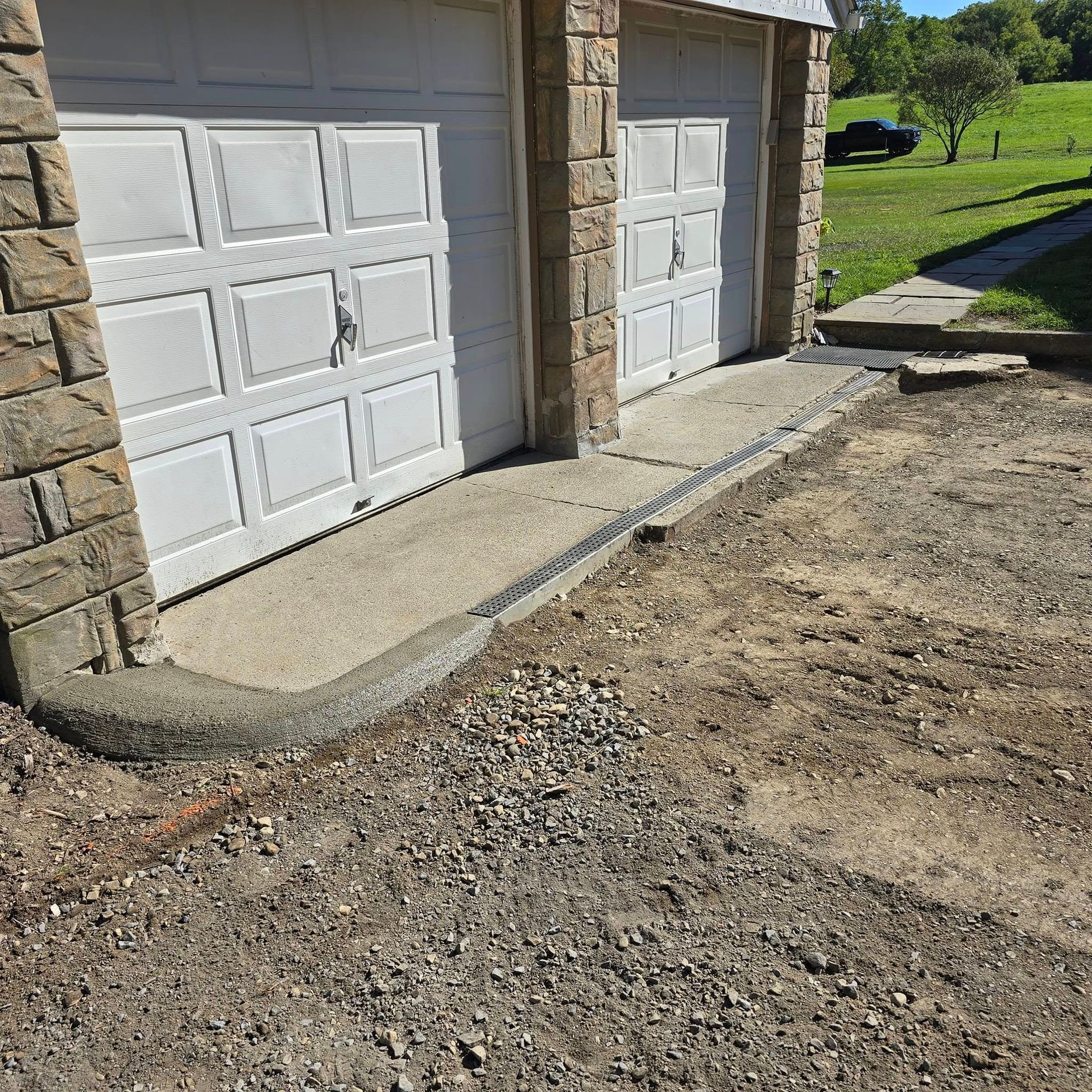 A couple of garage doors are sitting next to each other in a driveway.