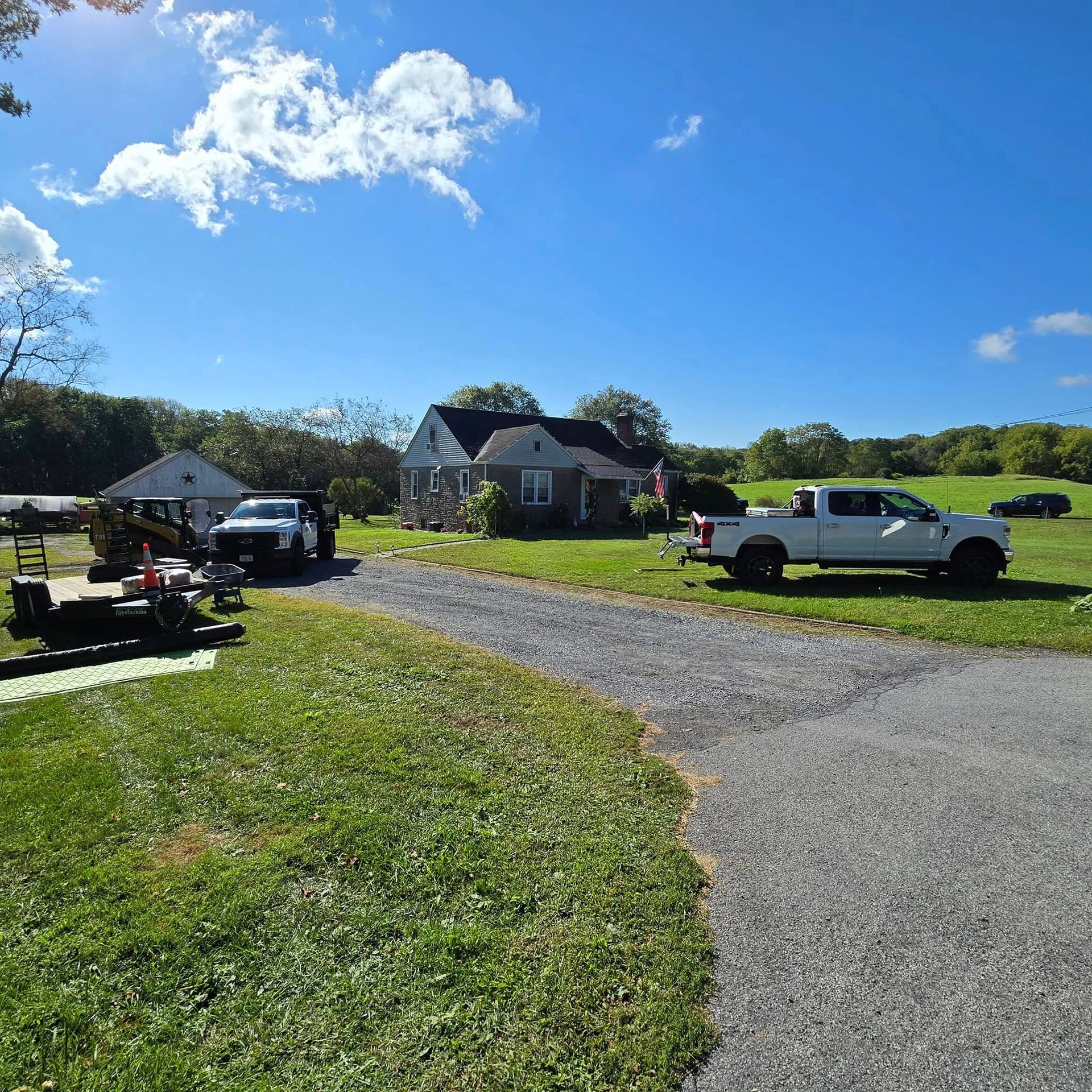 A white truck is parked in front of a house