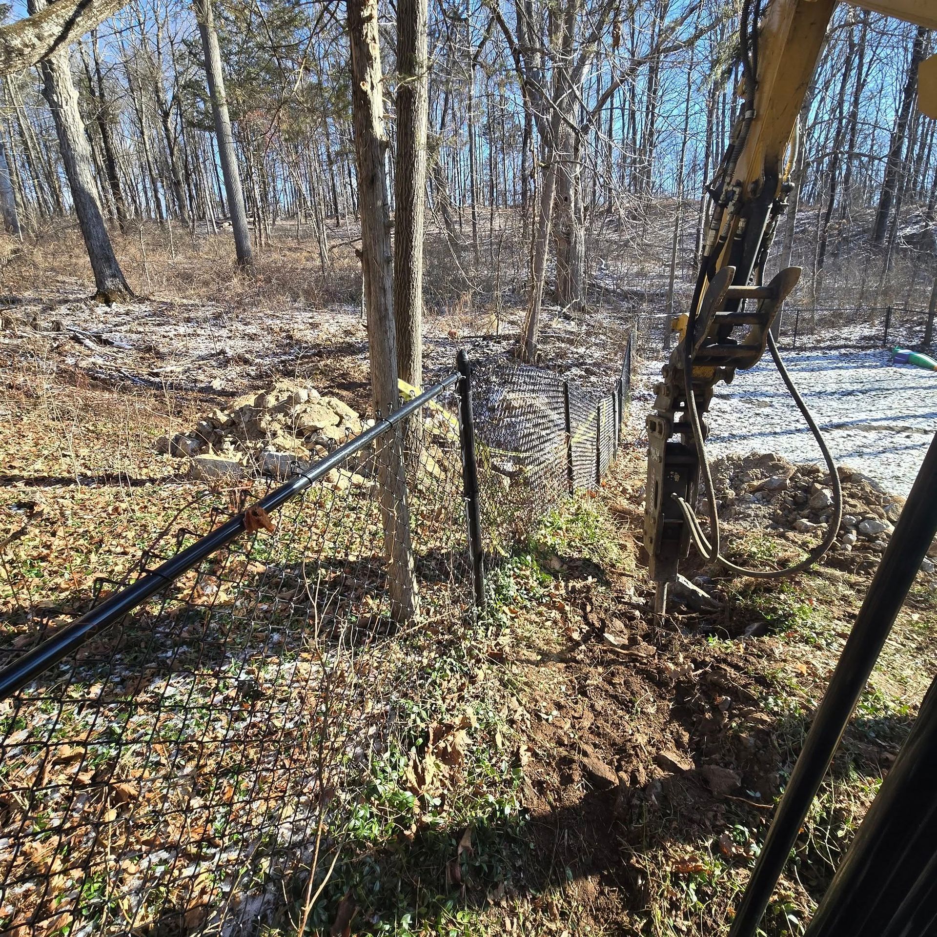 A fence is being built in the middle of a forest.