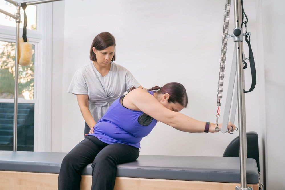 Woman Using the Twist Pilates Equipment