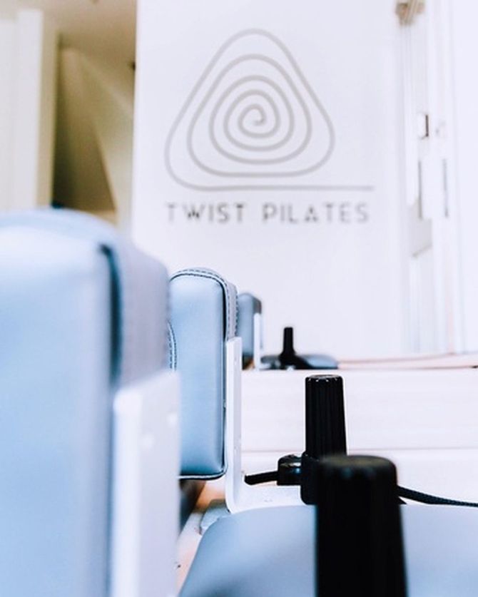 Twist Pilates Logo on the White Wall