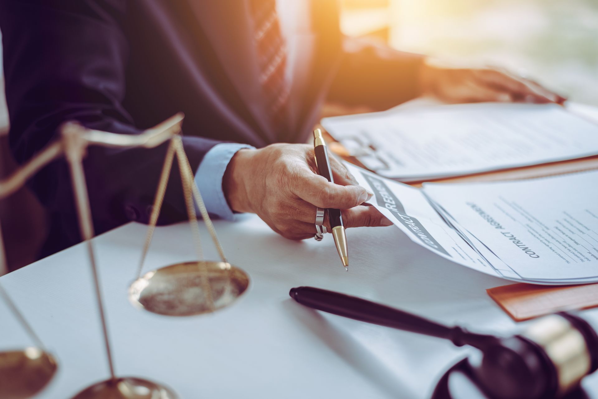 A person in a suit reviews legal documents representing business transaction attorney in Chicago.