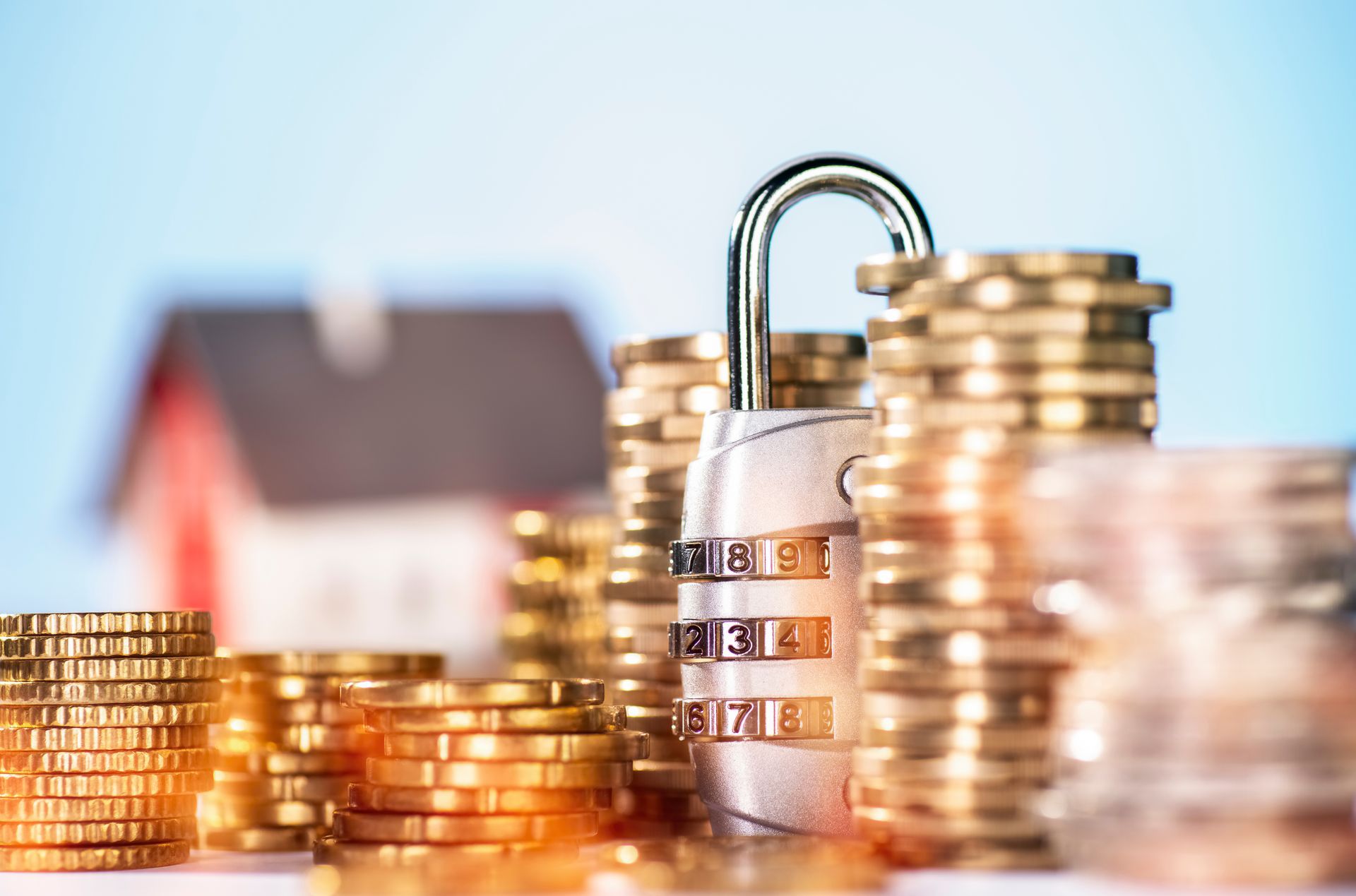 A padlock is sitting on top of a pile of gold coins.