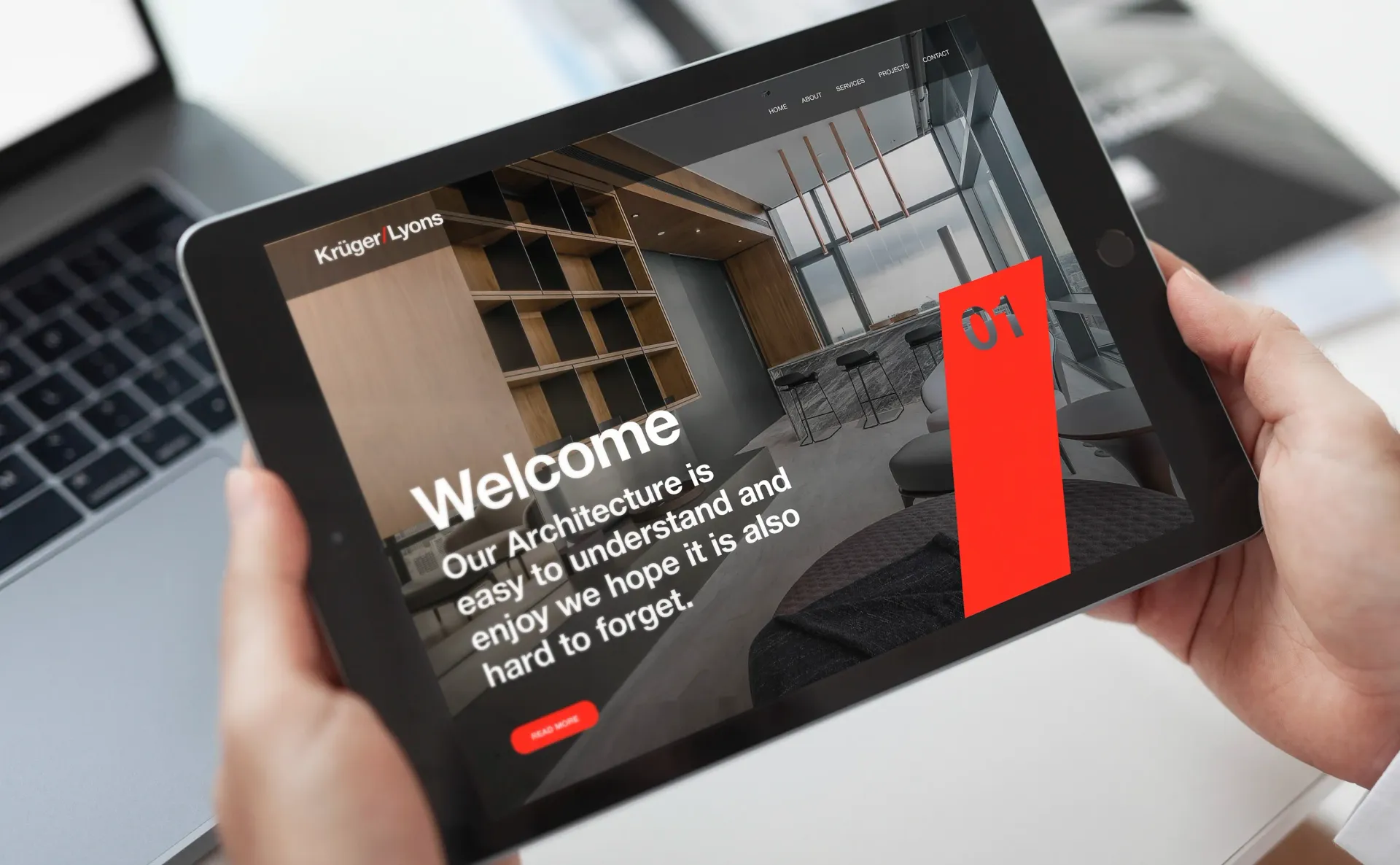 Person holding a tablet displaying a website welcome page with a room rendering.