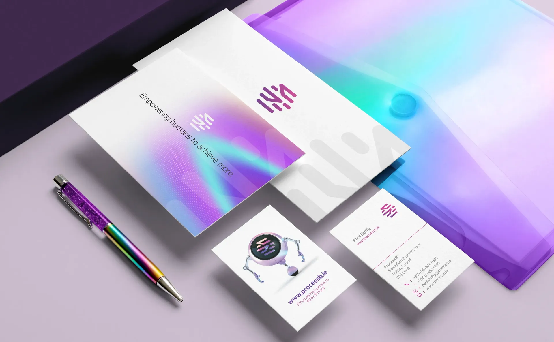 Stationery mockup with pen, folder, business cards, and envelopes, with a purple-toned color scheme.