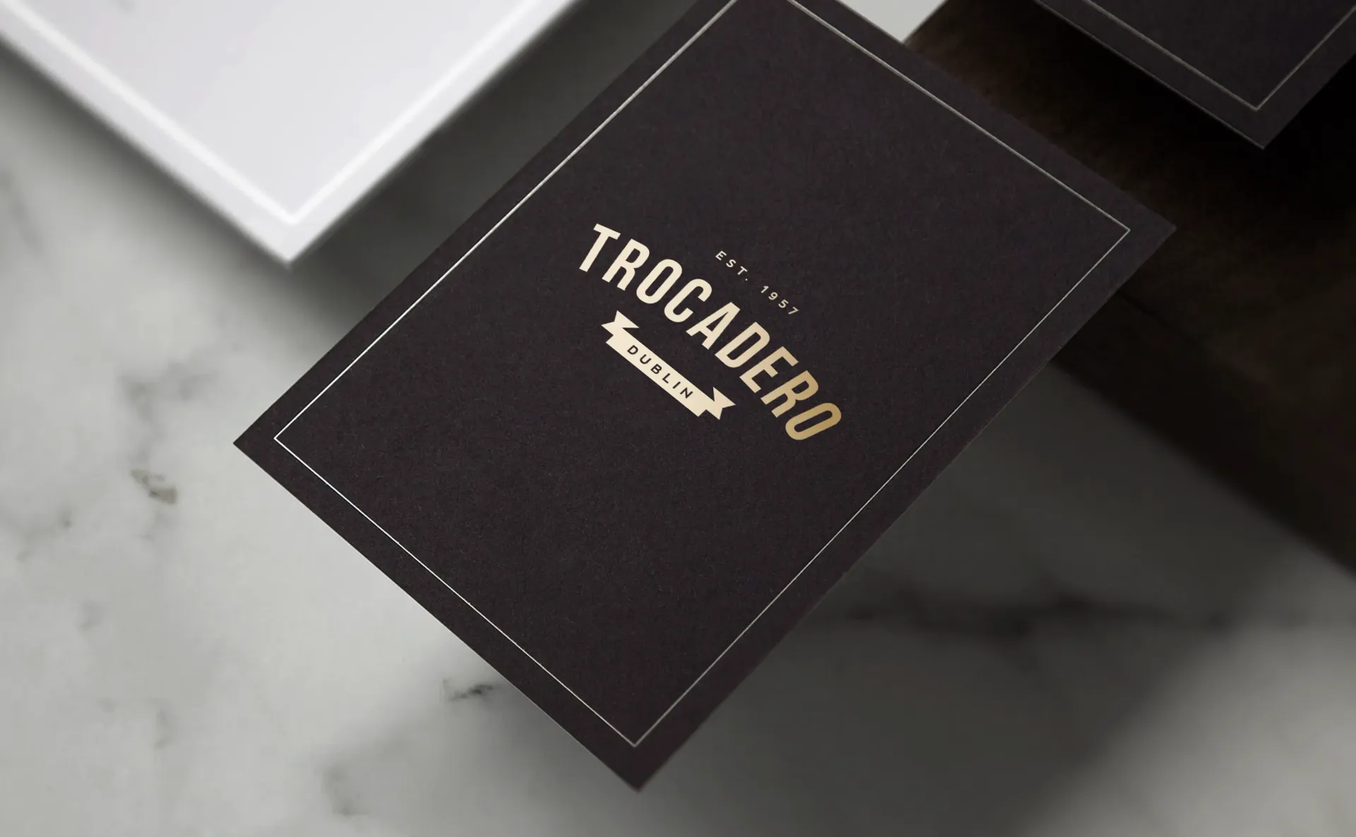 Black business card with gold text reading 