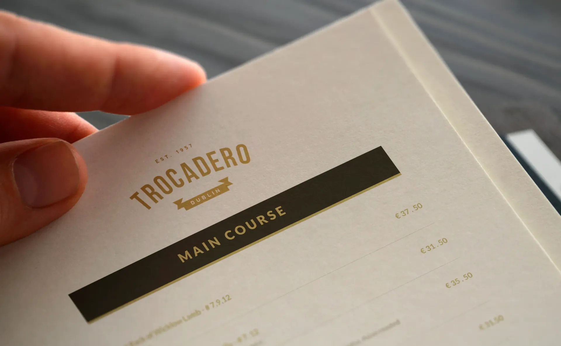 Person holding a menu open to the 