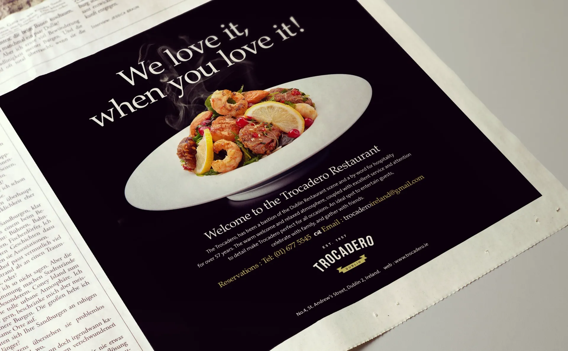 Black ad for restaurant, a white plate of food is in focus, text says 
