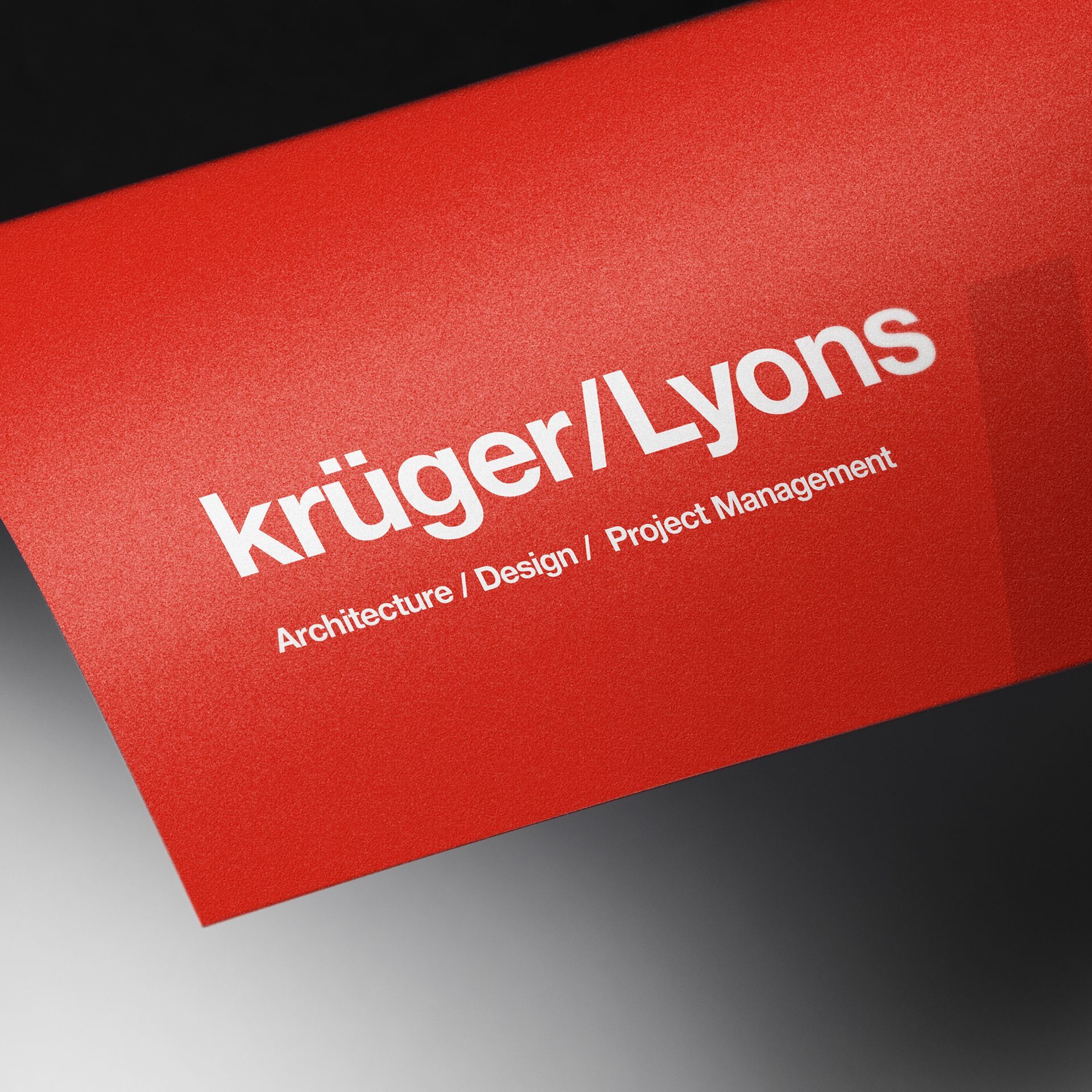 Red business card tilted at an angle with the name 