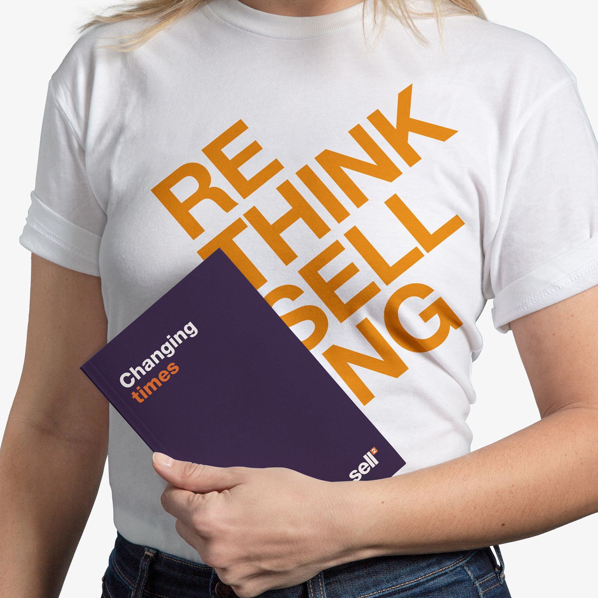 Person holding a purple book titled 