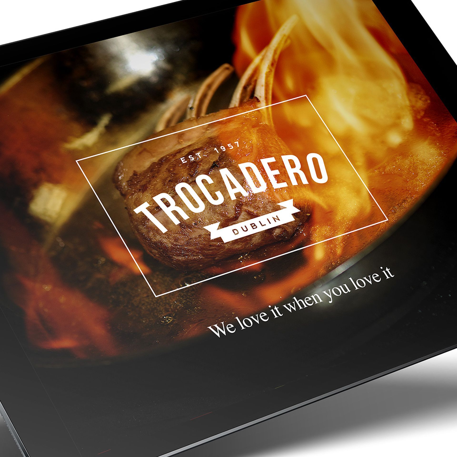 Restaurant advertisement with a close-up of roasting meat in a pan, logo 