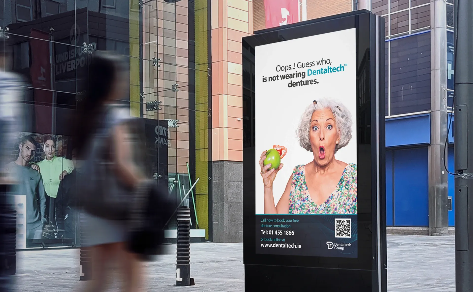 Outdoor ad: woman reacting to apple, text reads 
