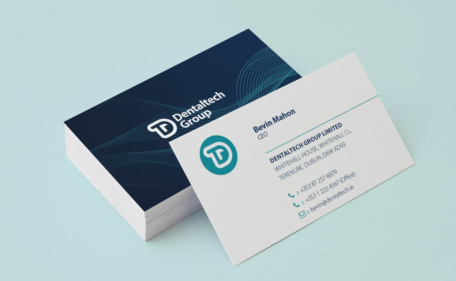 Business cards with a teal logo for Dentaltech Group.