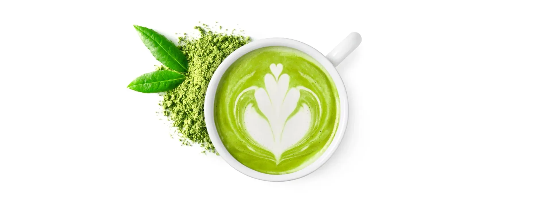 A matcha latte in a white cup, with leaves and matcha powder.