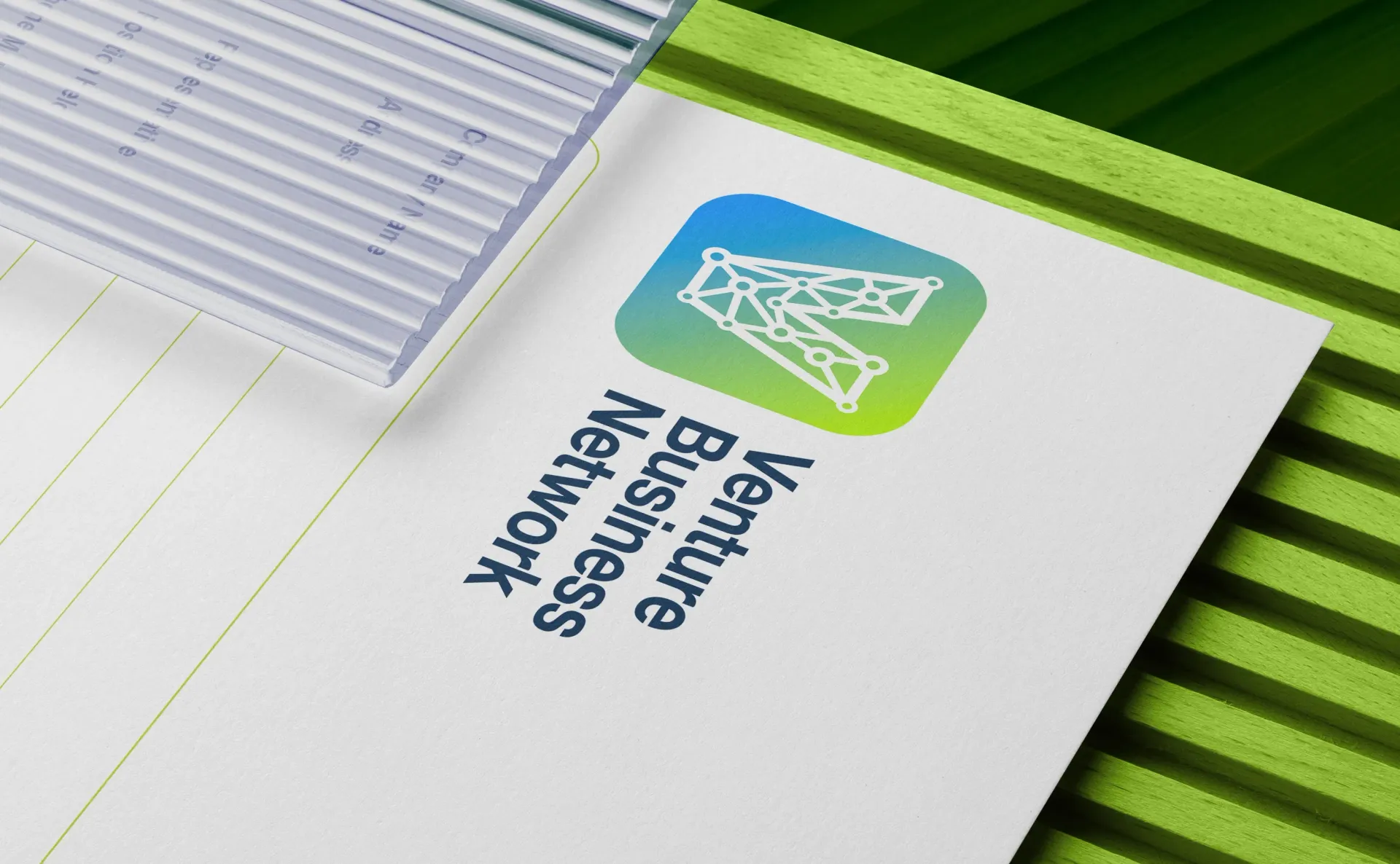Logo for Venture Business Network on a white surface with green and gray striped textures.