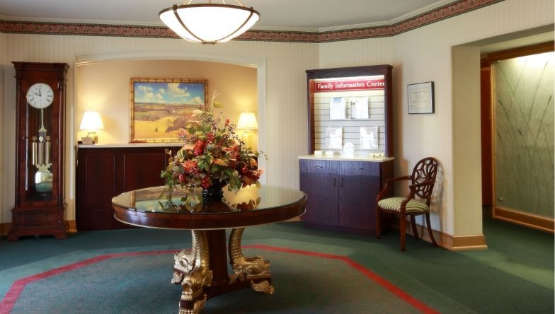 A room with a round table and a clock on the wall