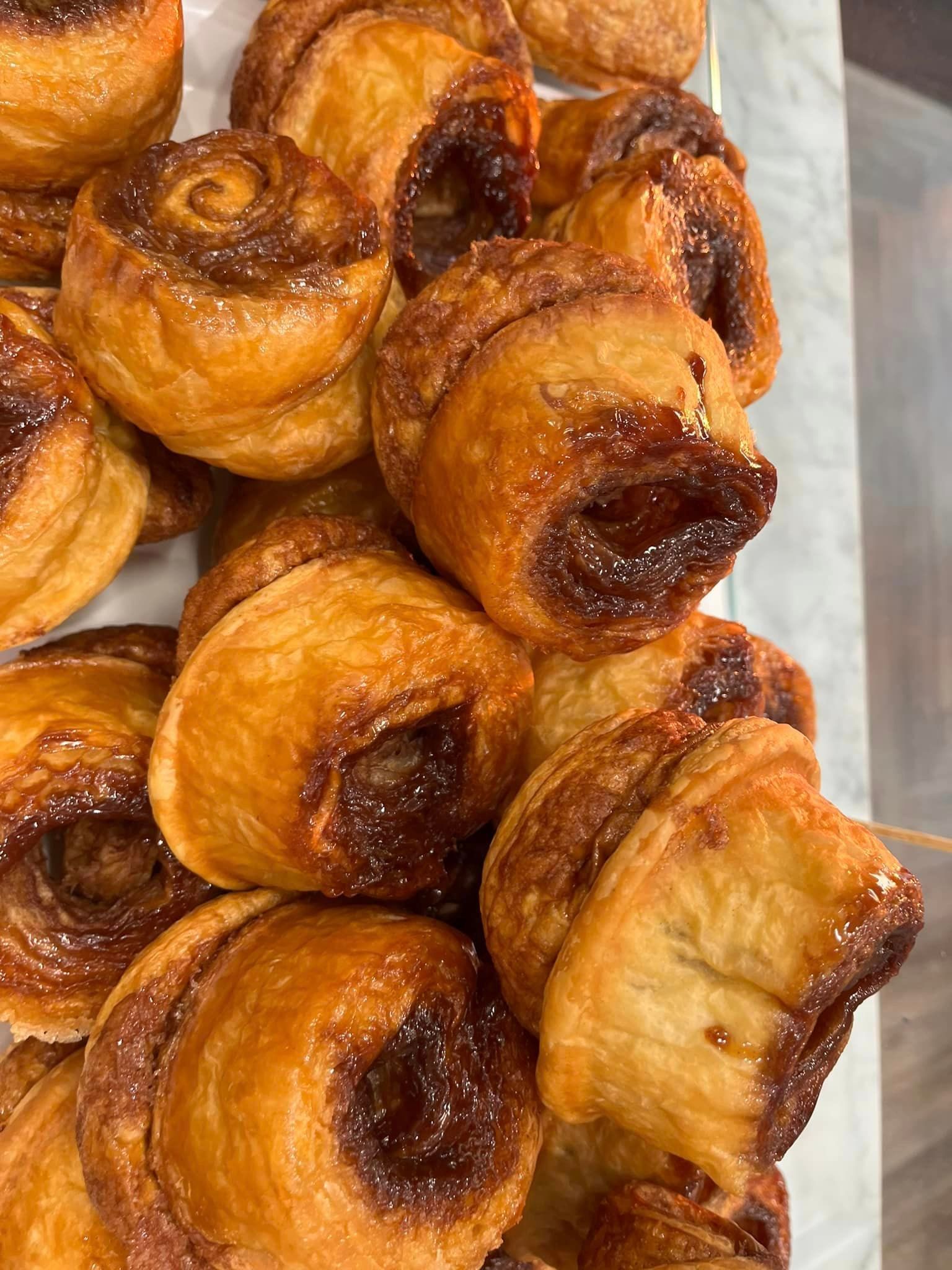 A bunch of pastries are sitting on top of each other on a table.