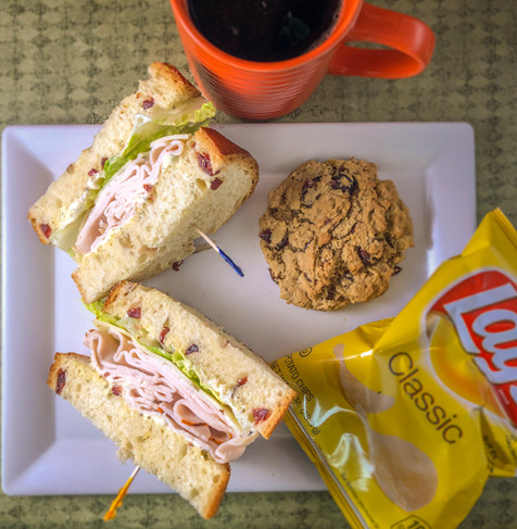 A bunch of cinnamon rolls are on a white plate.