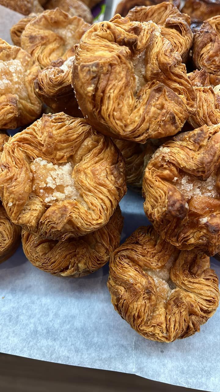 A bunch of pastries are stacked on top of each other on a table.