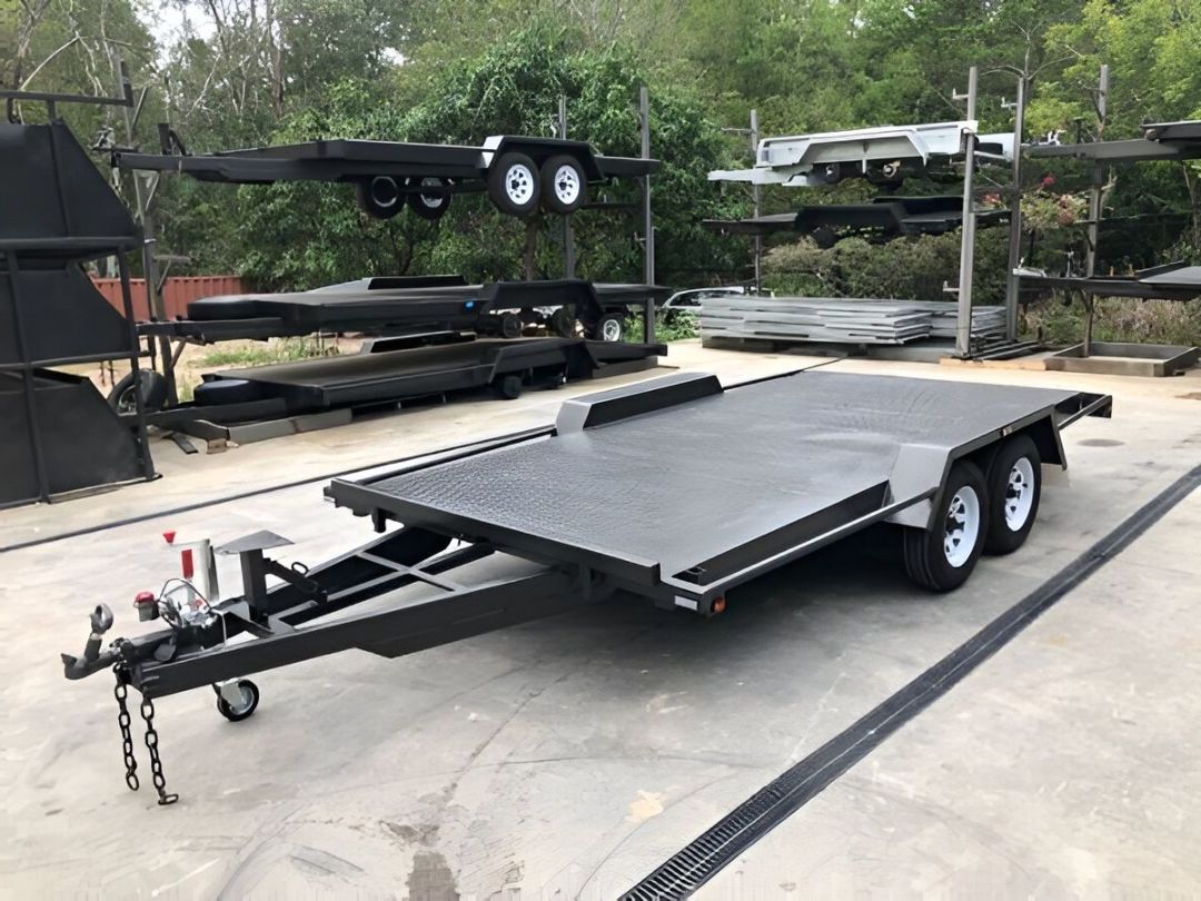 Two Trailers Are Parked In A Parking Lot In Front Of A Building — B2B Hire In Garbutt, QLD