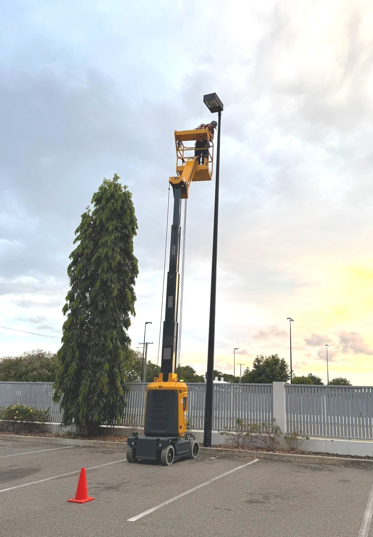 Two Scissor Lifts Are Parked In Front Of A Building — B2B Hire In Garbutt, QLD
