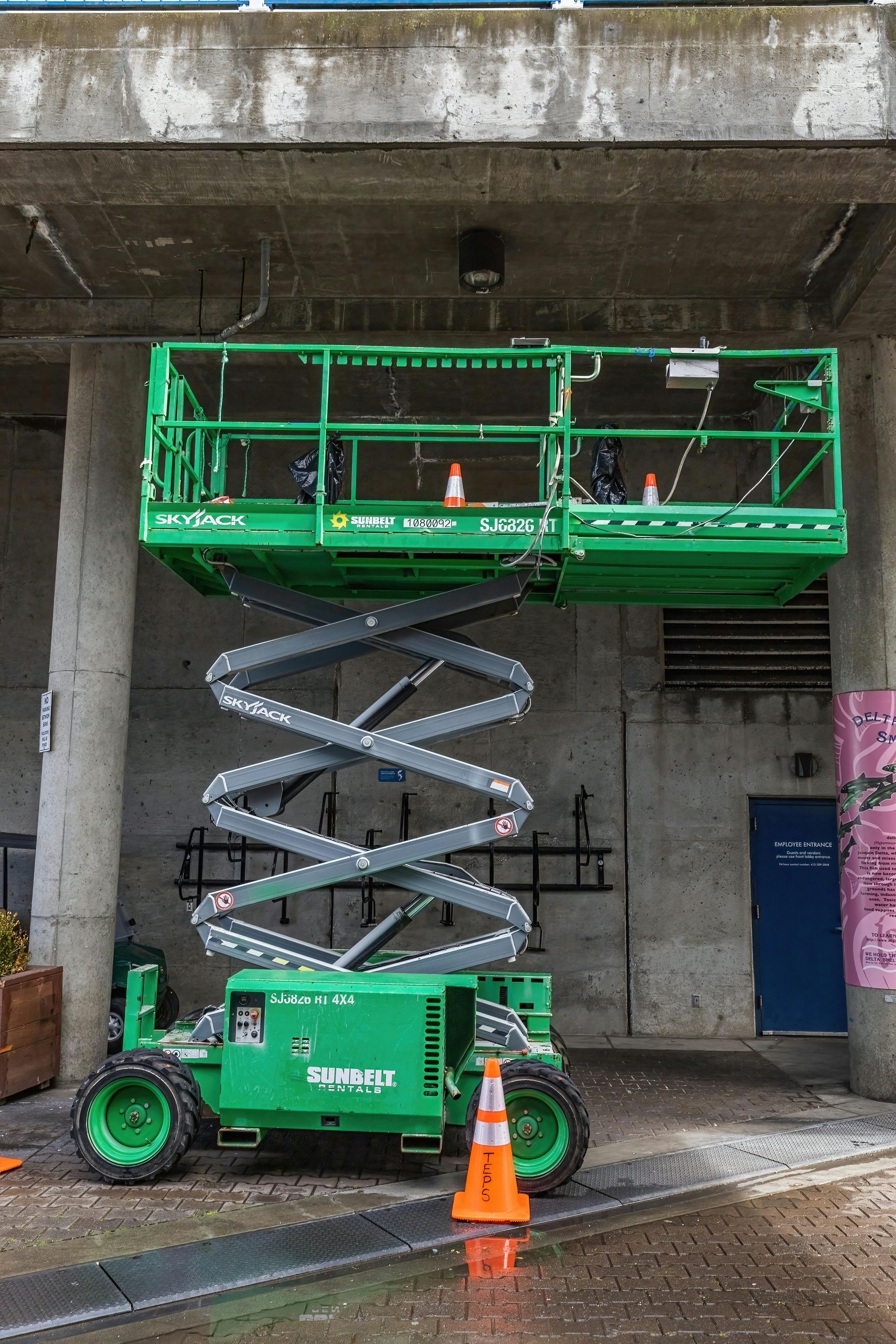 A yellow scissor lift is sitting on a white background — B2B Hire In Garbutt, QLD