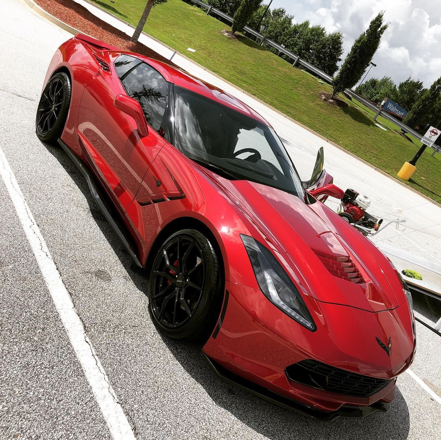 A red sports car is parked on the side of the road