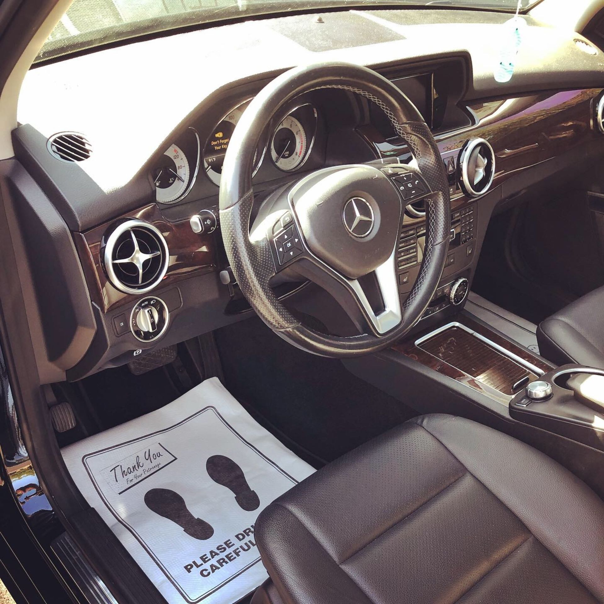 The inside of a car with a paper that says please be careful