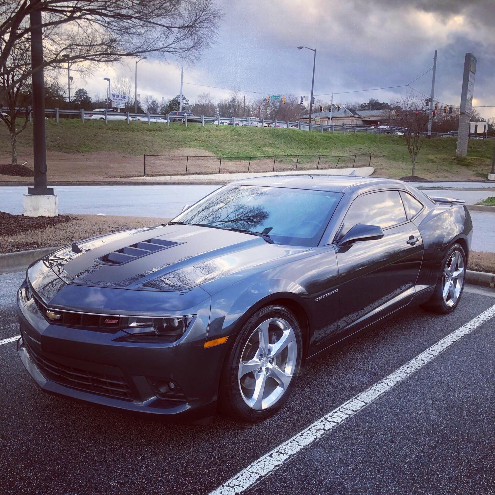 A black car is parked in a parking lot