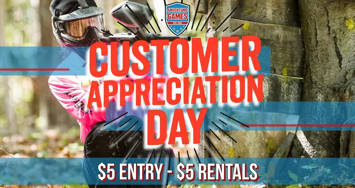 People playing paintball at an outdoor event;