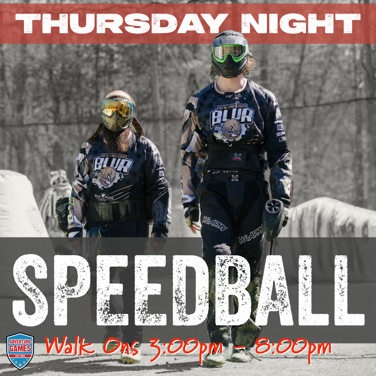 Two people in paintball gear at a speedball event on a Thursday night.