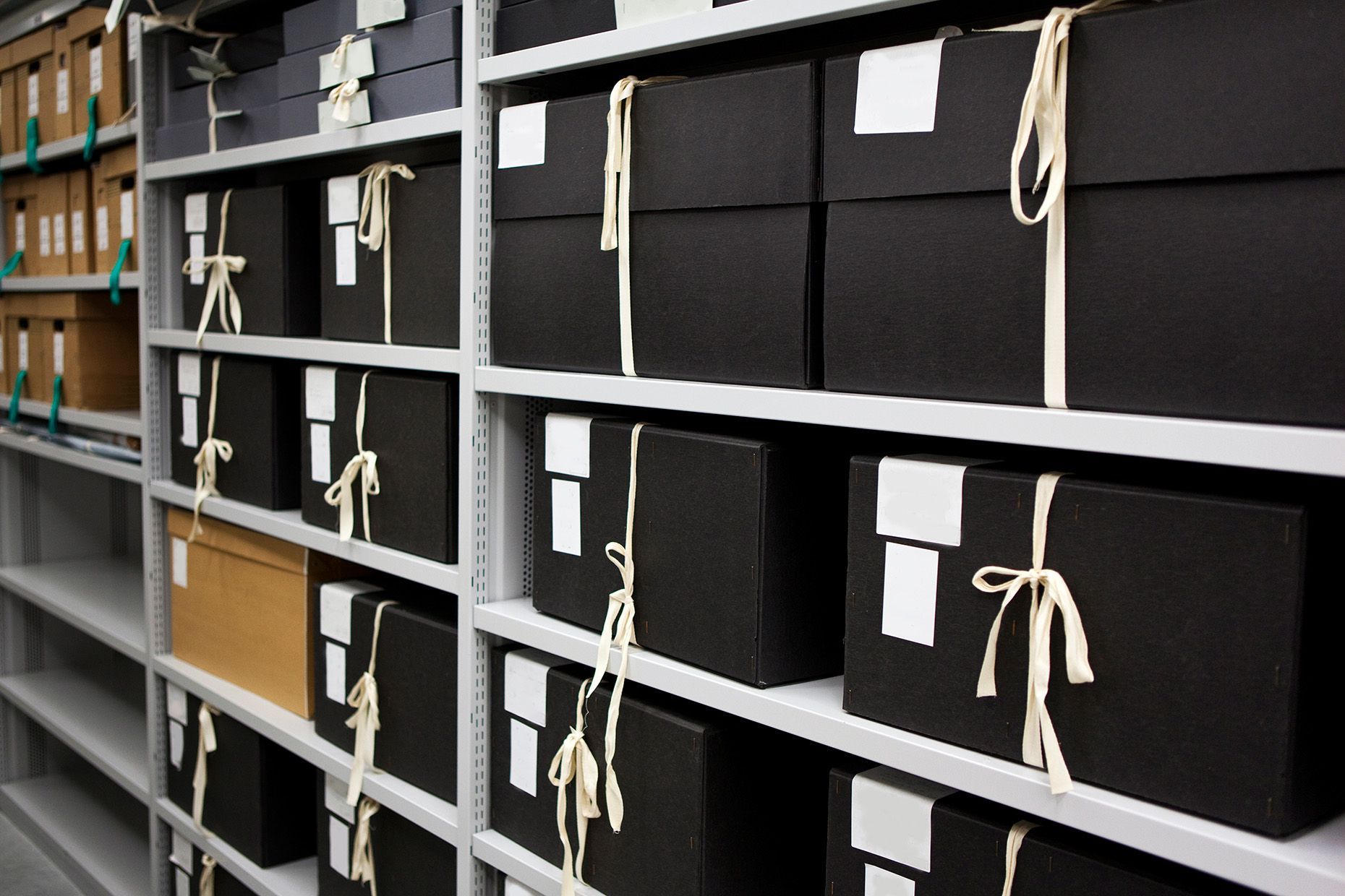 a row of shelves with black boxes on them | BXB3 Corporation | Archive Solutions in CA
