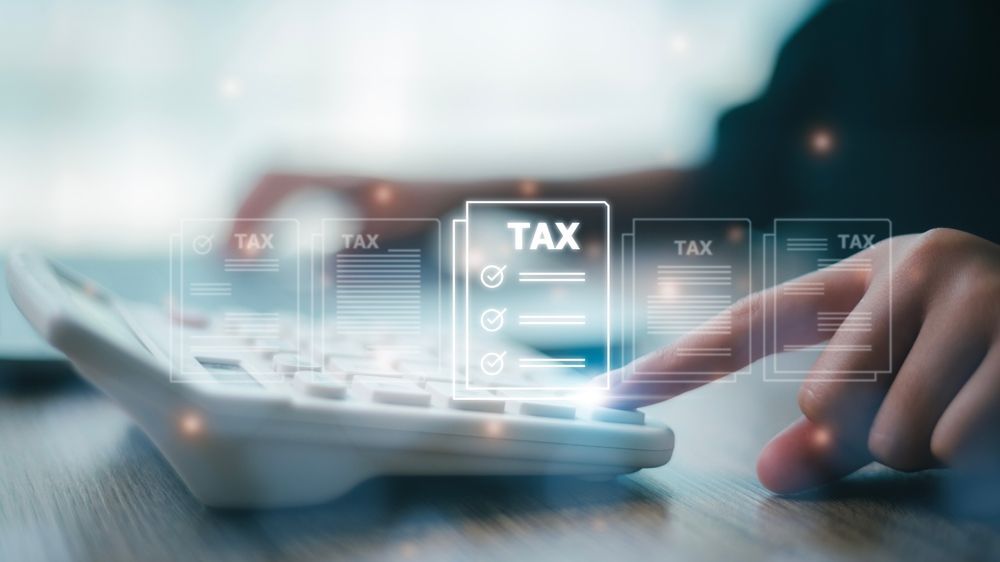 A person is using a calculator to calculate taxes.