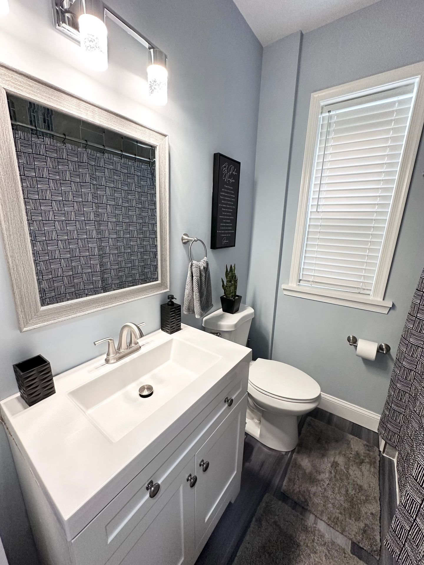 A bathroom with a sink , toilet and mirror