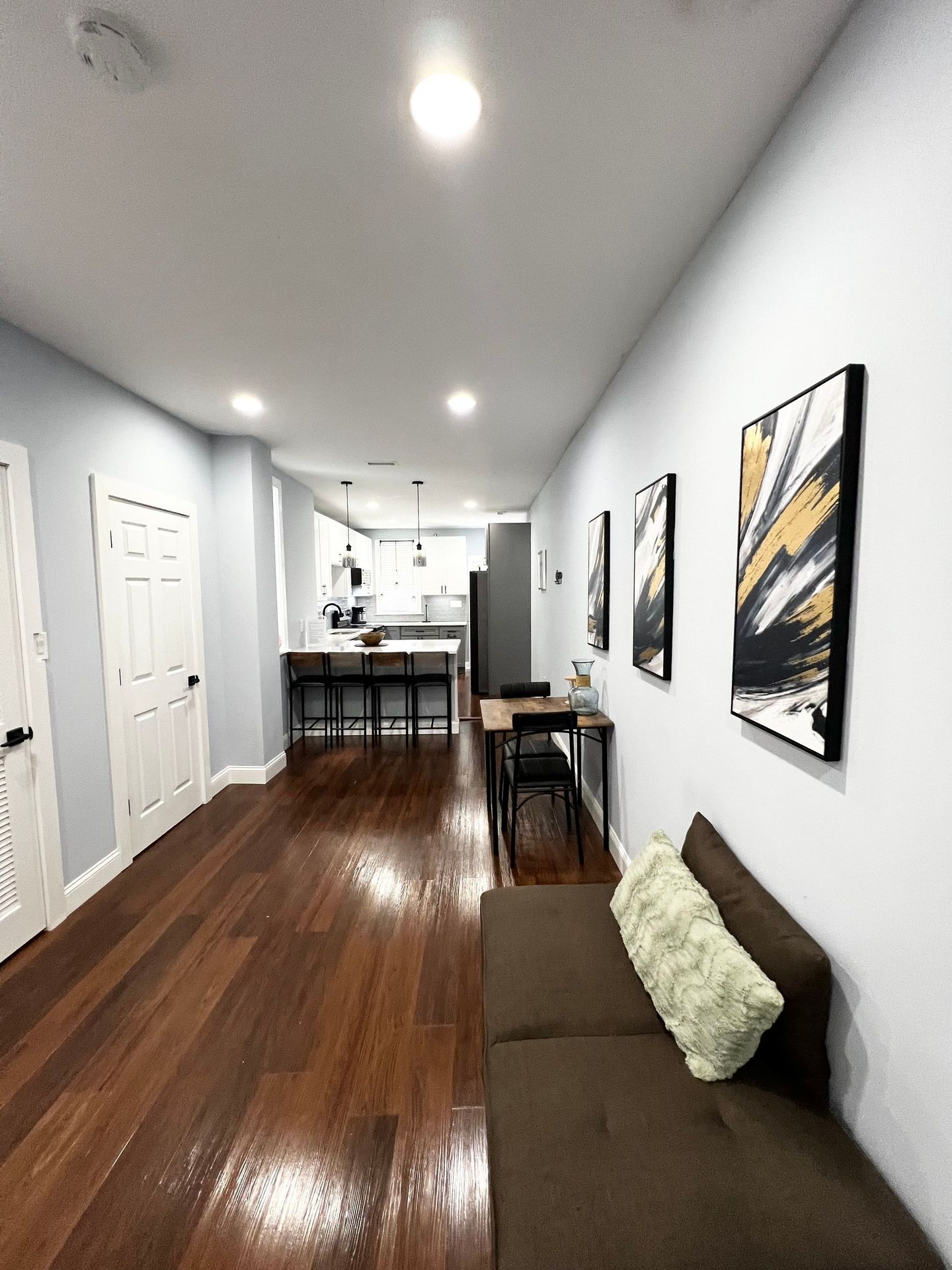 A living room with hardwood floors and a couch