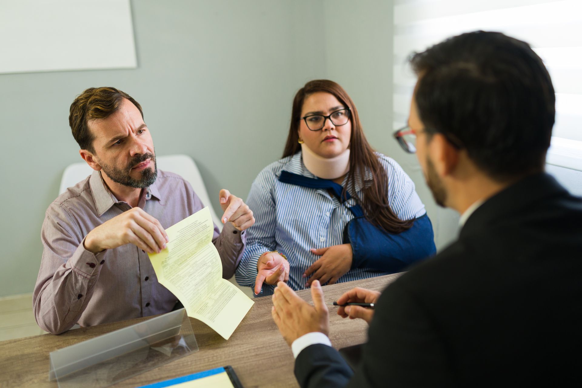 An injury lawyer consulting accident victims during legal case review.
