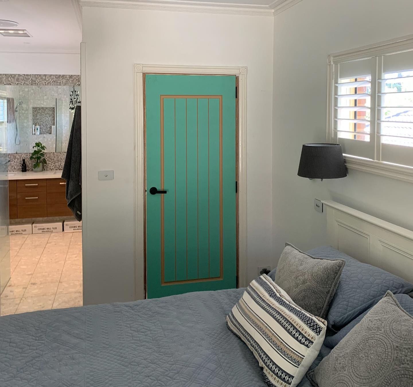 A Green door is in a bedroom with a bathroom — Flintoff Constructions in Charlemont, VIC