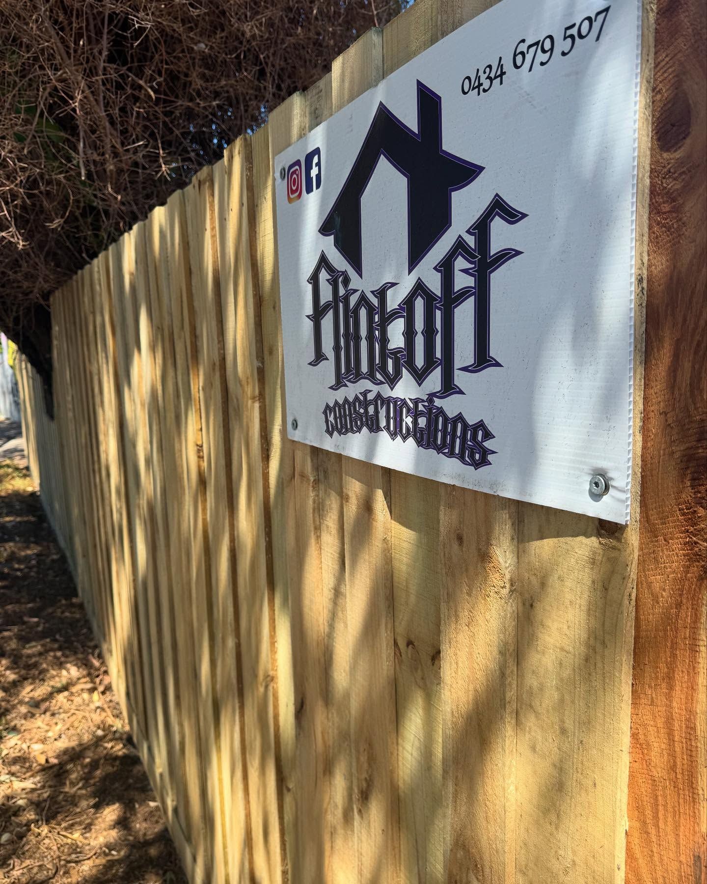 A close up of a wooden fence with a sign on it — Flintoff Constructions in Charlemont, VIC