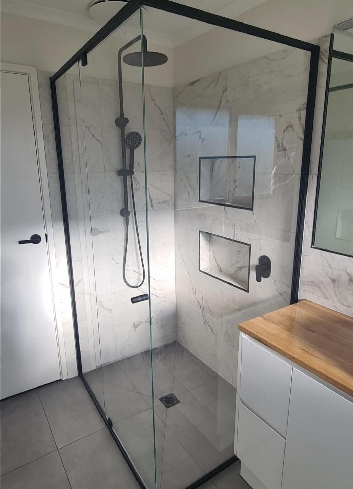 A Bathroom with a shower and marble walls — Flintoff Constructions in Charlemont, VIC